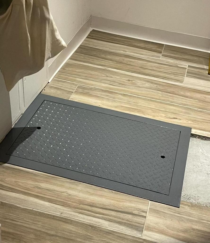 Black diamond-plate floor hatch installed flush