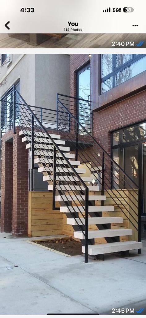Modern staircase with metal railing on brick building