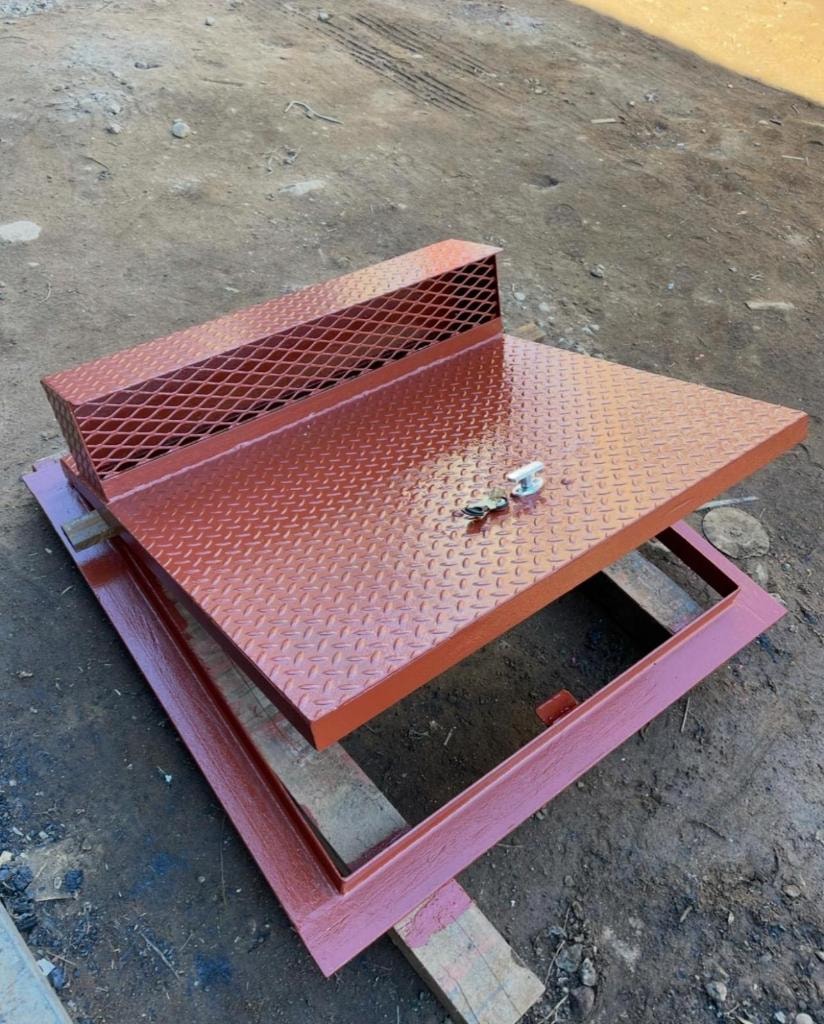 Red primer diamond-plate cellar door on pallet