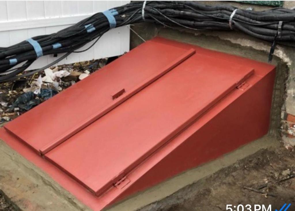 Red painted angled cellar door installed