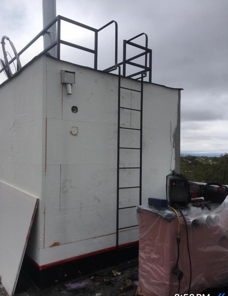 Industrial rooftop structure metal ladder railing