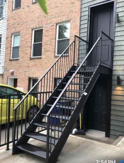 Black metal exterior staircase on brick residential building