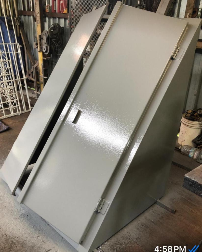 Gray painted cellar door in fabrication shop