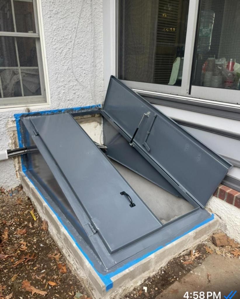 Basement window wells with metal covers