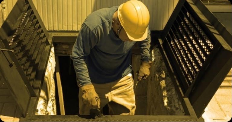 Worker inspecting cellar door installation