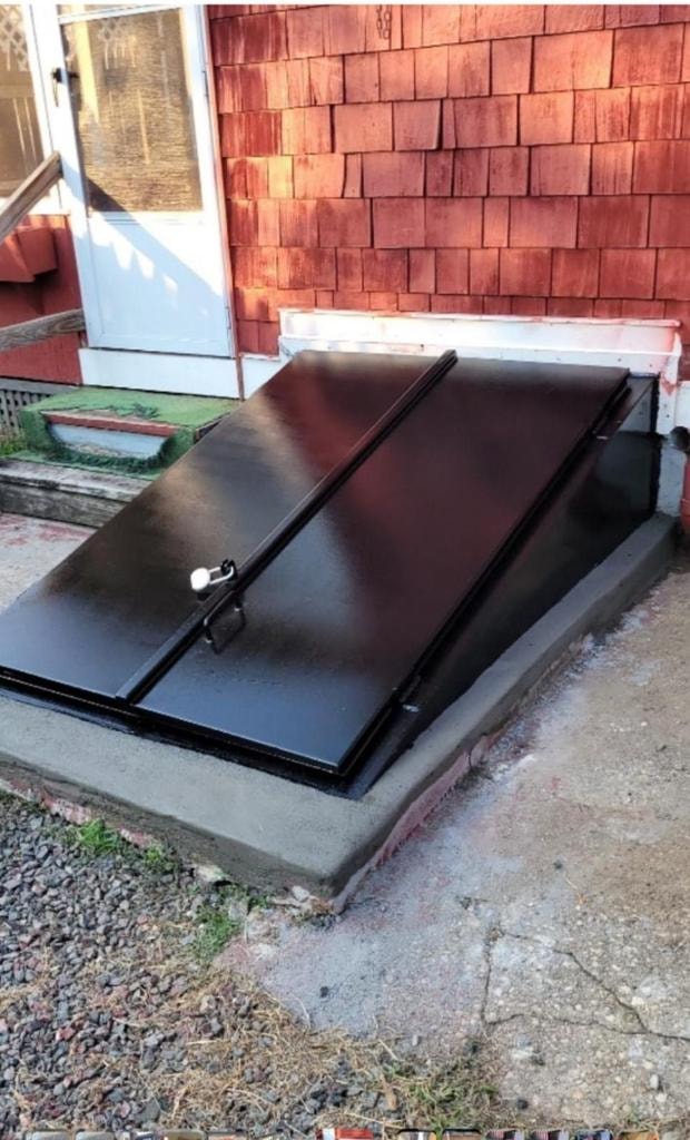 Black sidewalk door installed on NYC building